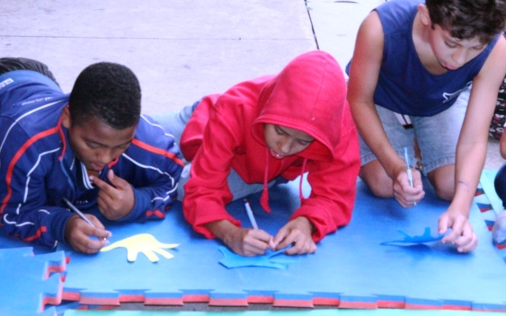 Alunos são convidados a refletirem sobre suas qualidades e registrá-las em um papel; Pouco a pouco, os professores conseguem a participação e envolvimento dos estudantes. Foto: Franciele Xavier (SEE/MG)